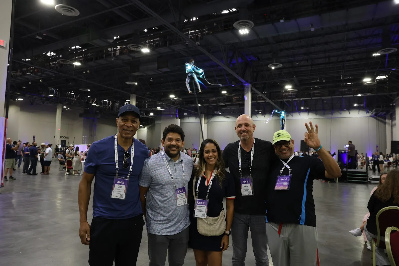 Ai4 2026 attendees on the expo floor beneath aerial performers at The Venetian